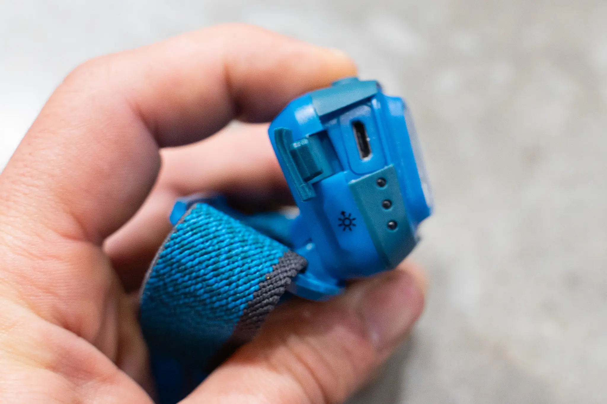 Close-up of a modern headlamp showing its integrated USB charging port.