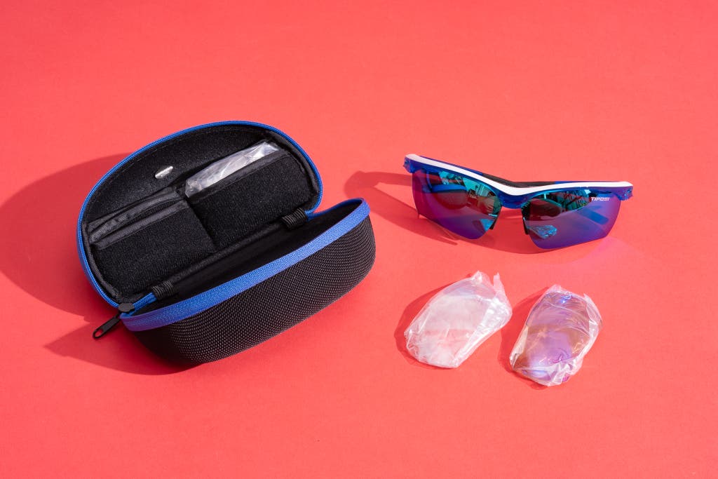 Tifosi brand sunglasses shown with a hard-shell zip case and extra interchangeable lenses.