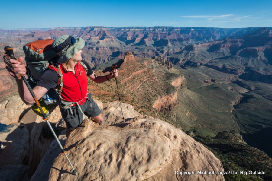 A backpacker navigating a steep descent at Ooh-Ah Point on the South Kaibab Trail in the Grand Canyon.
