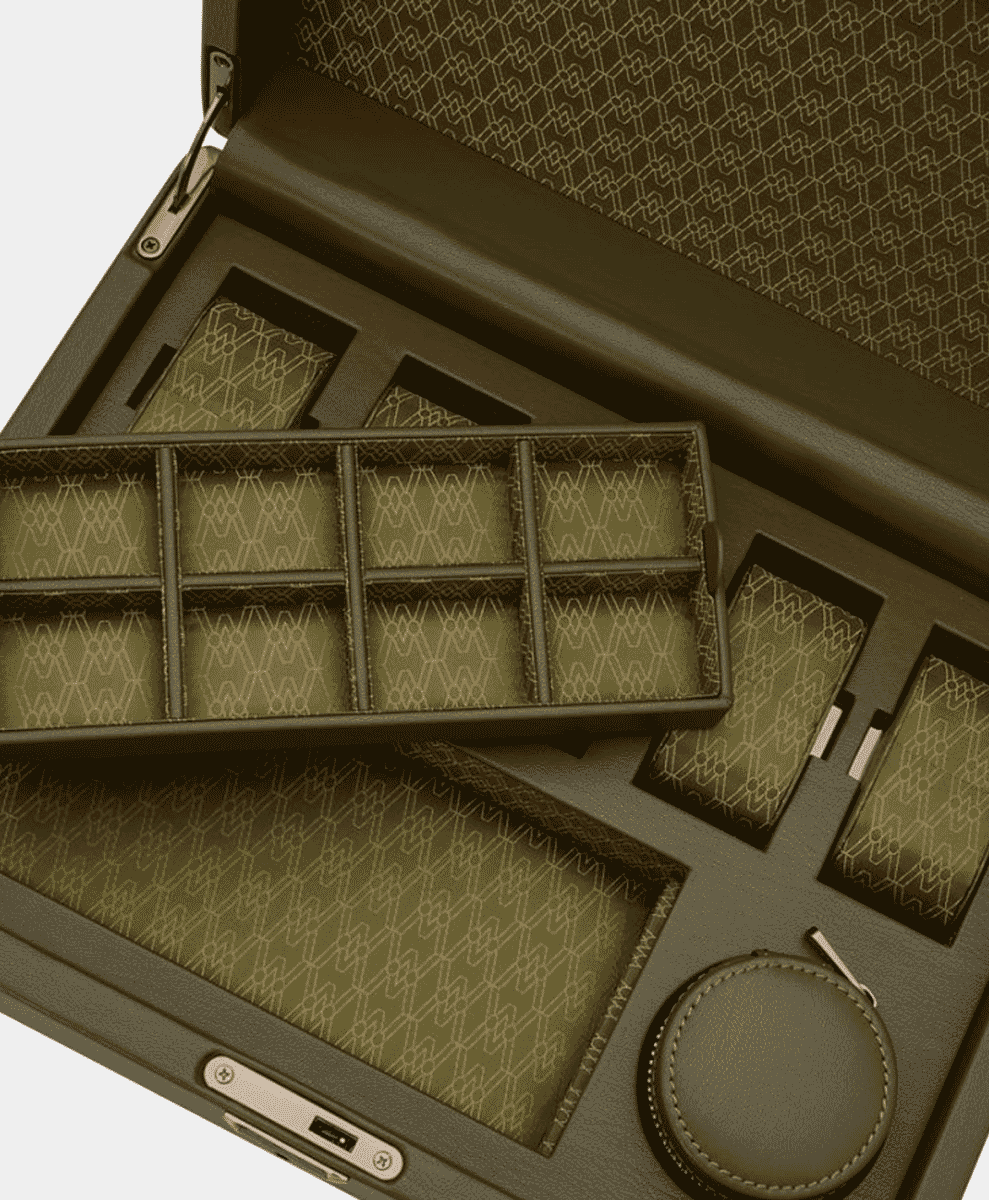 A wide-angle shot of a leather watch box with multiple compartments and accessories.