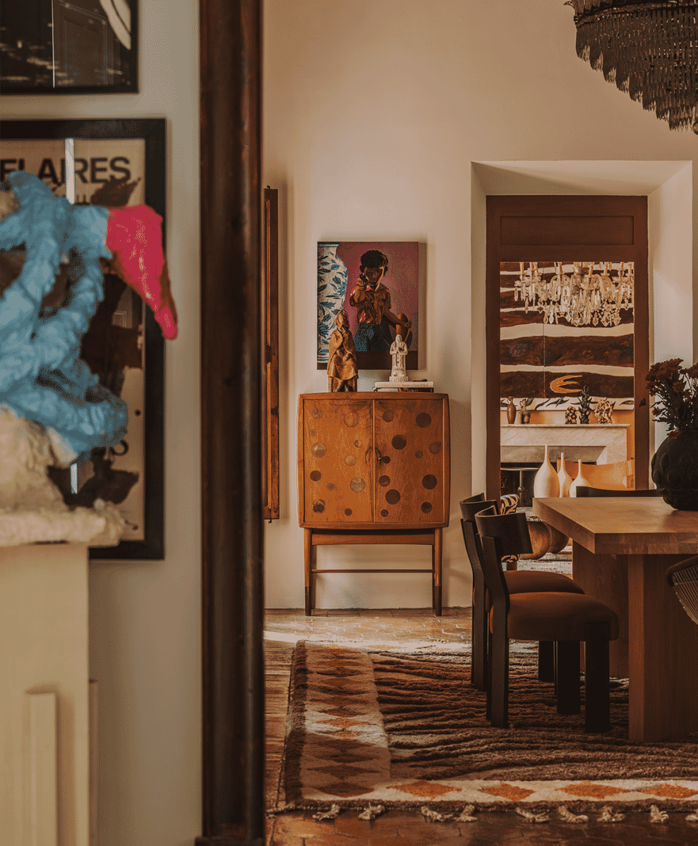 Mid-century modern cabinet paired with abstract art and warm-toned interior decor.