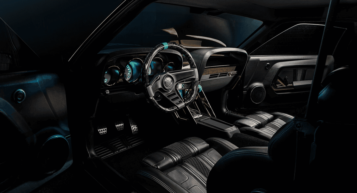 Interior view of a luxury muscle car with black leather seats and illuminated Dakota Digital gauges.