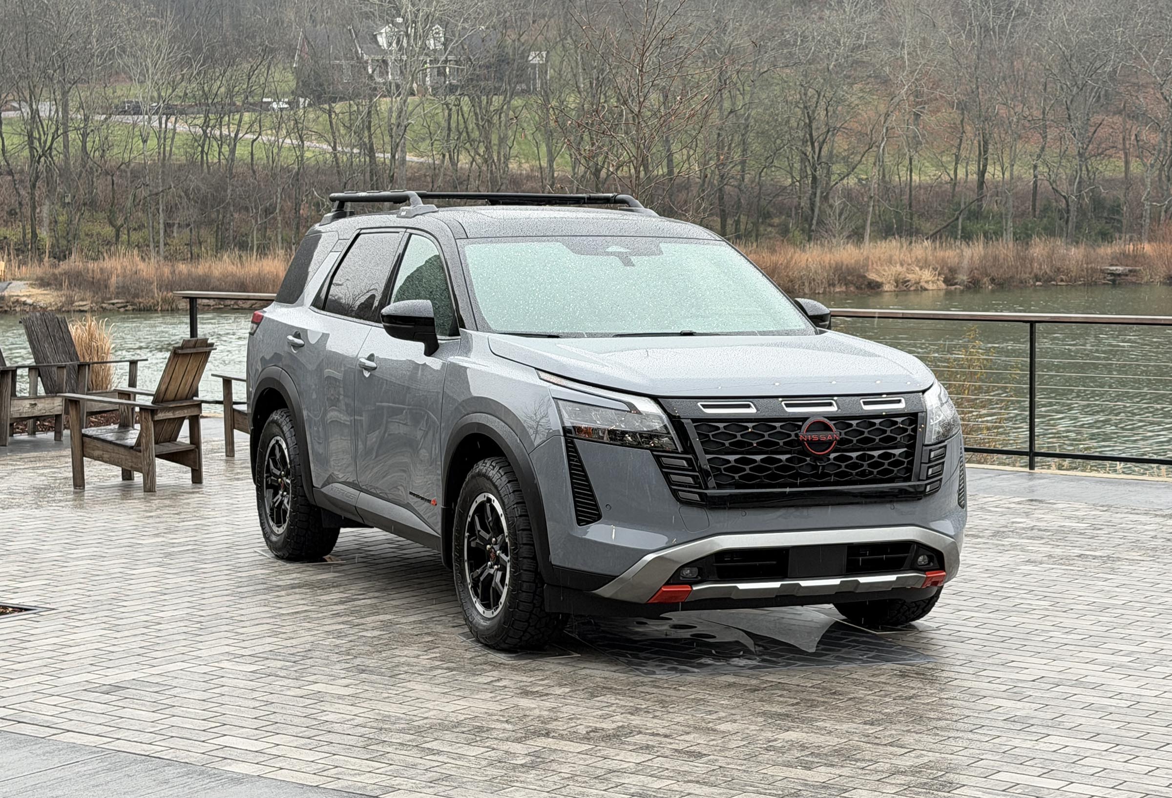 A front three-quarter view of the 2026 Nissan Pathfinder on a paved road, highlighting its updated exterior design.