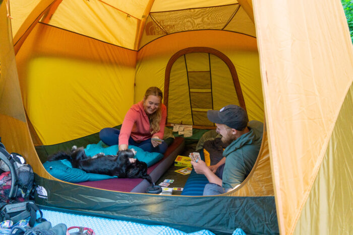 The interior of a North Face Wawona 4 tent with camping gear and a dog.