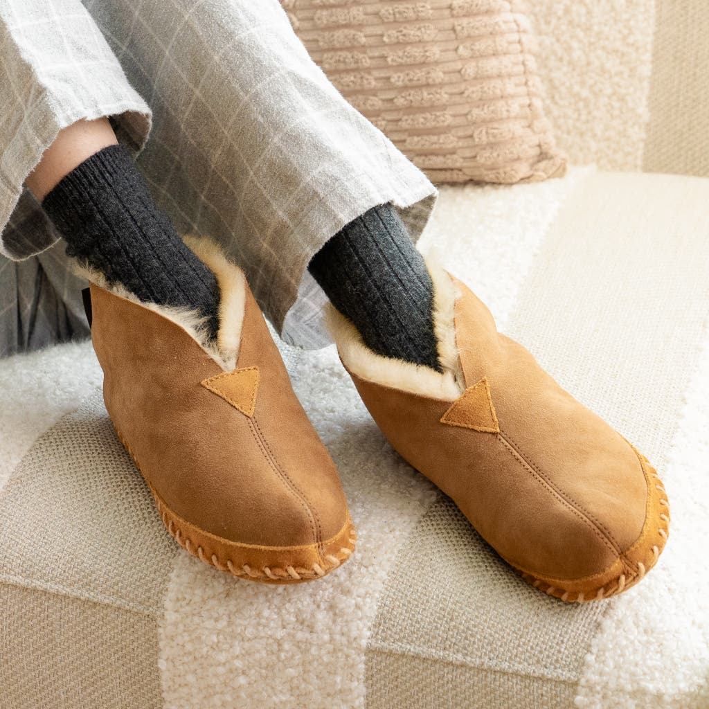 A close-up view of the interior and exterior of L.L.Bean Wicked Good Moccasin slippers.