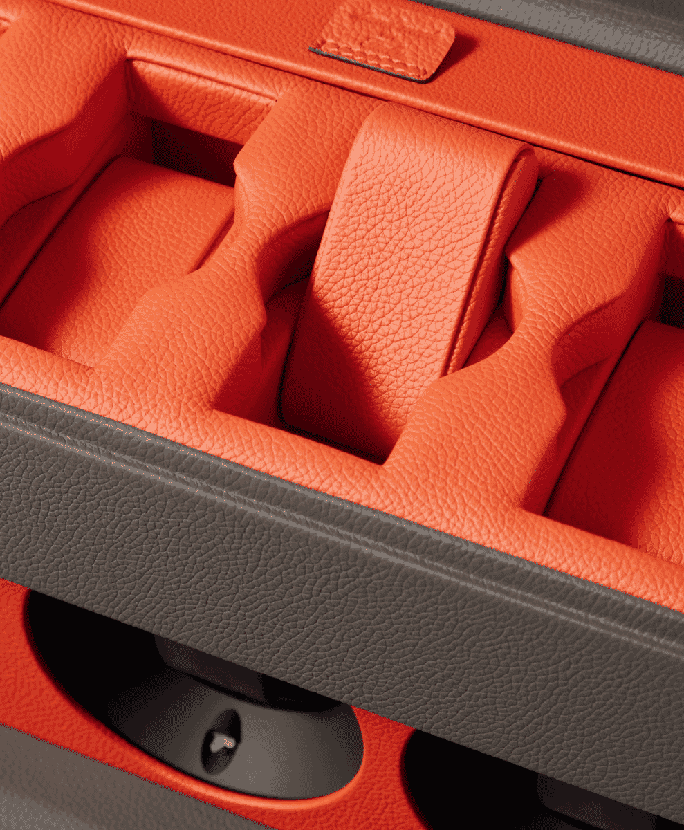 Macro shot of vibrant orange textured leather lining in a watch box.