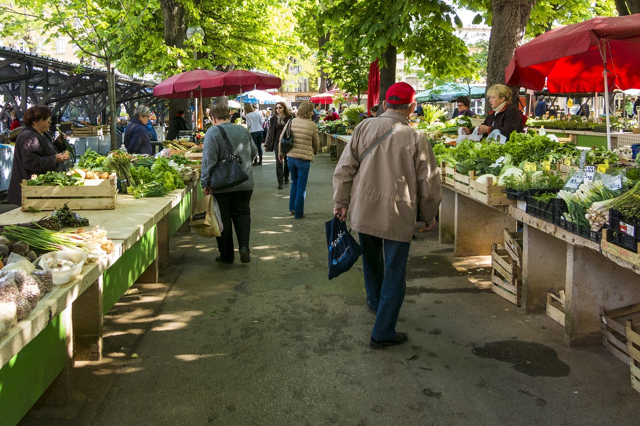 Diverse group of friends sharing a simple meal at an outdoor street market.