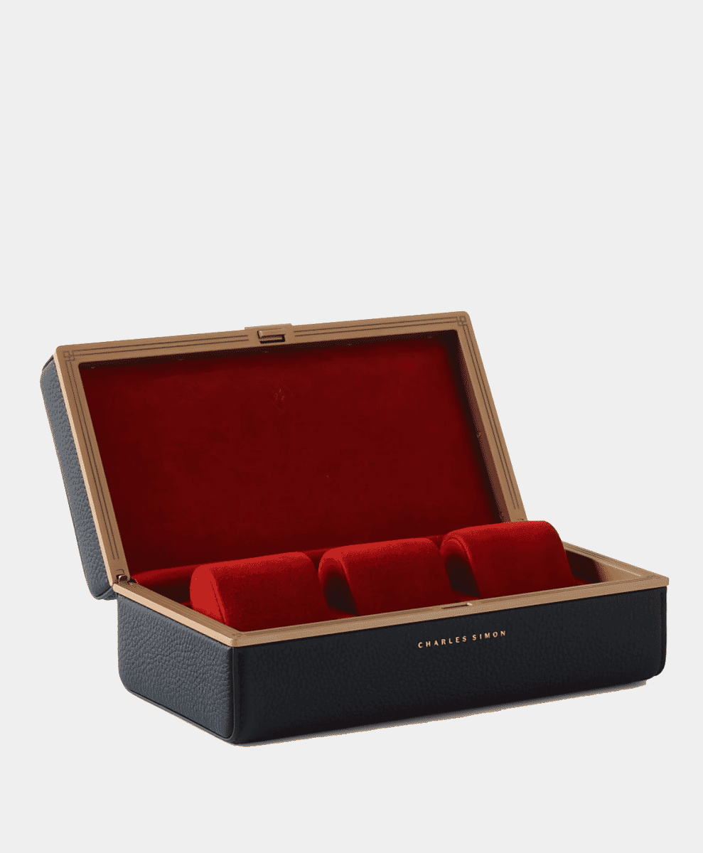 Charles Simon watch box with a black exterior and red velvet interior.
