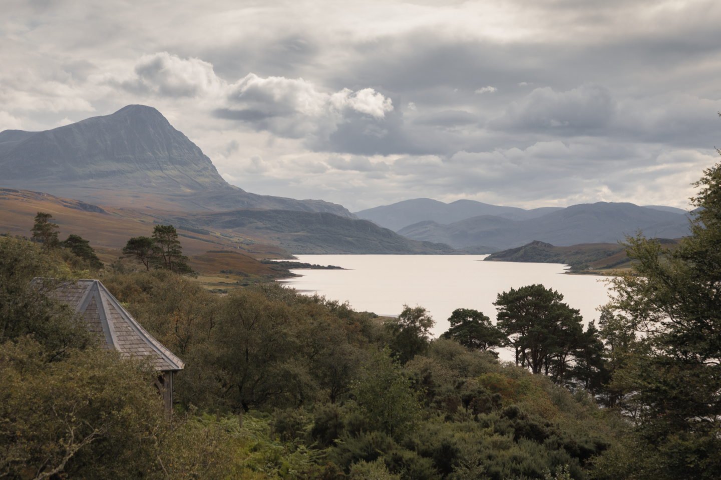A misty and rugged coastal mountain landscape reminiscent of the Icelandic South Coast.