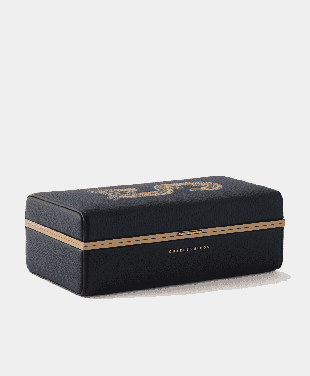Black leather watch box with a gold embossed dragon design and logo.