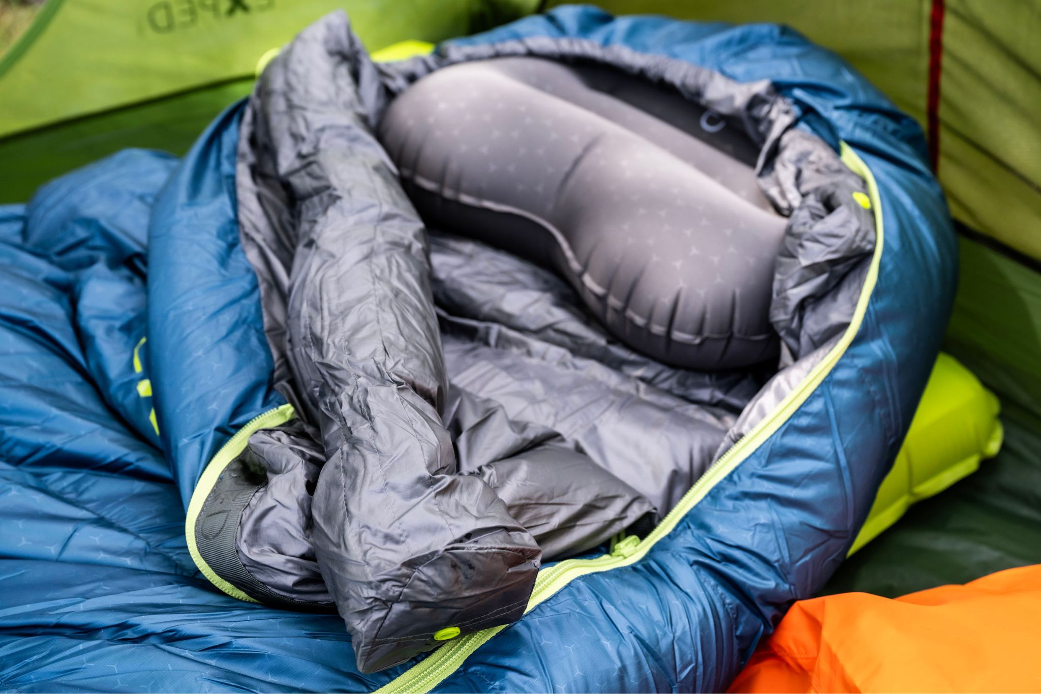 An unzipped EXPED Terra sleeping bag laid out inside a tent, showing the lining and zipper.