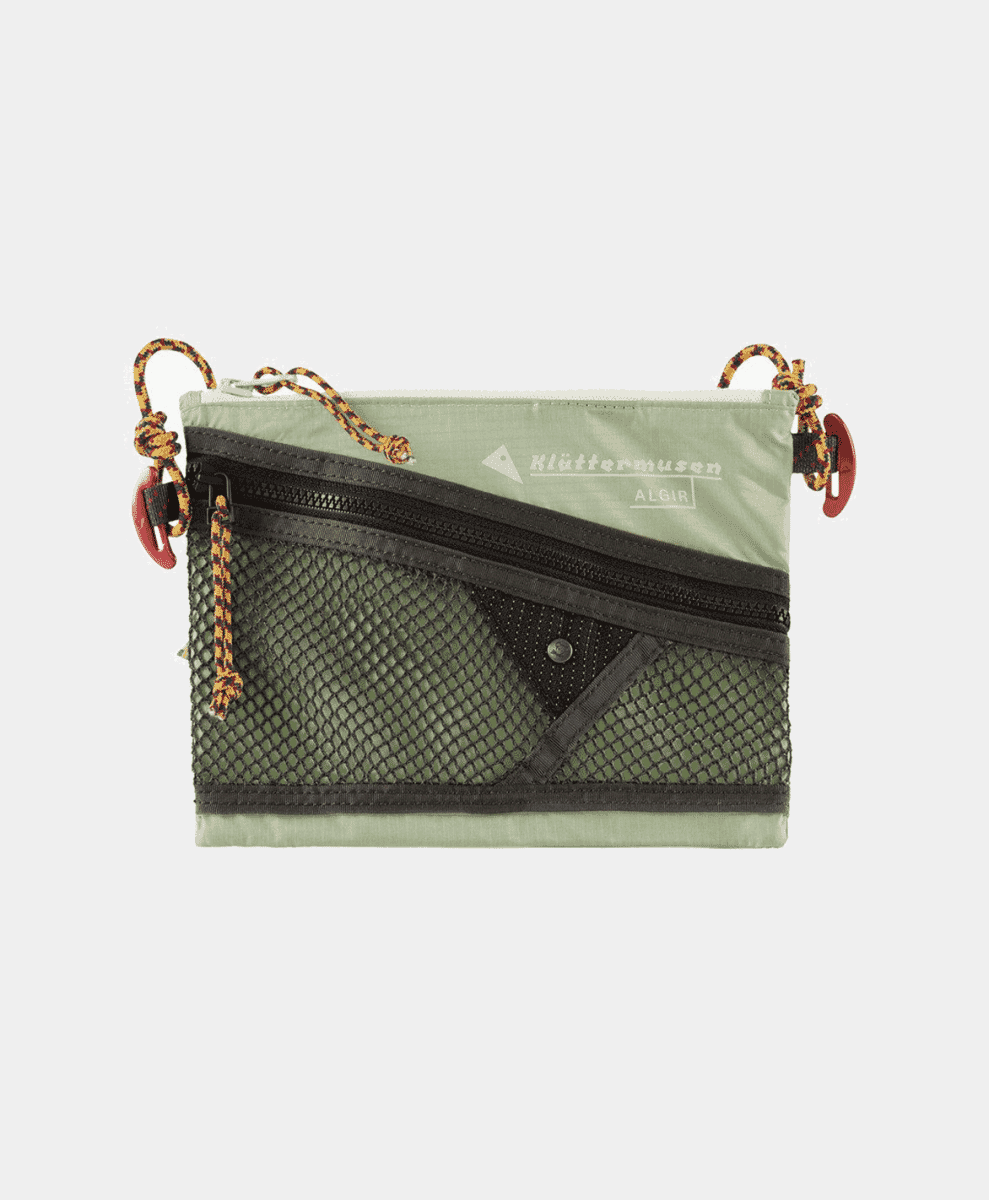 An olive-green Klättermusen Algir mesh accessory bag with orange pull cords.