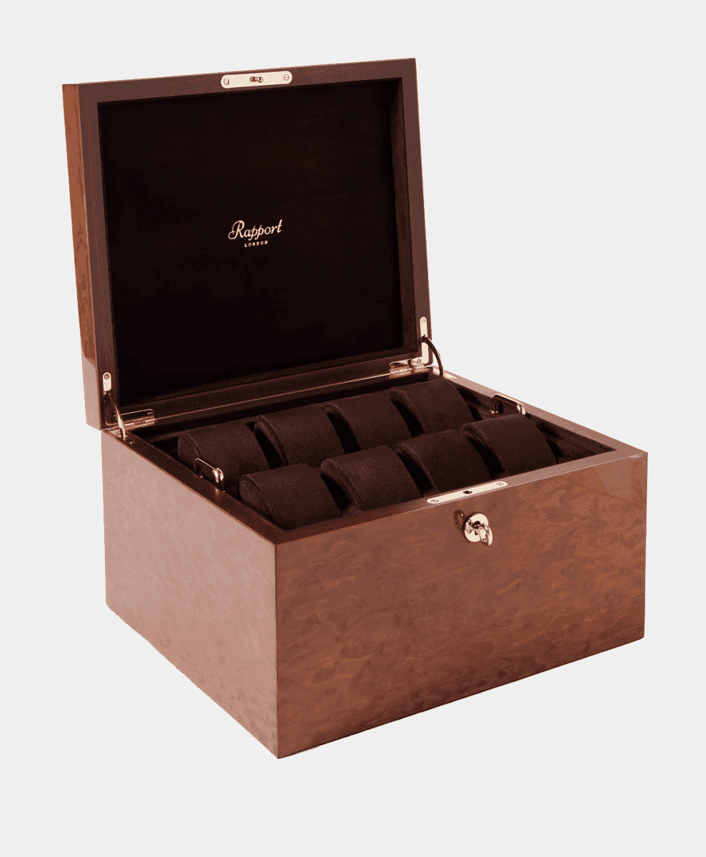 An open Rapport London wooden watch box with six velvet-lined compartments.