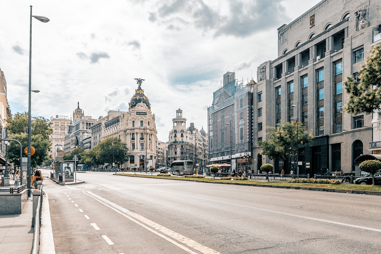 The iconic Metropolis building and Madrid skyline seen from a rooftop.